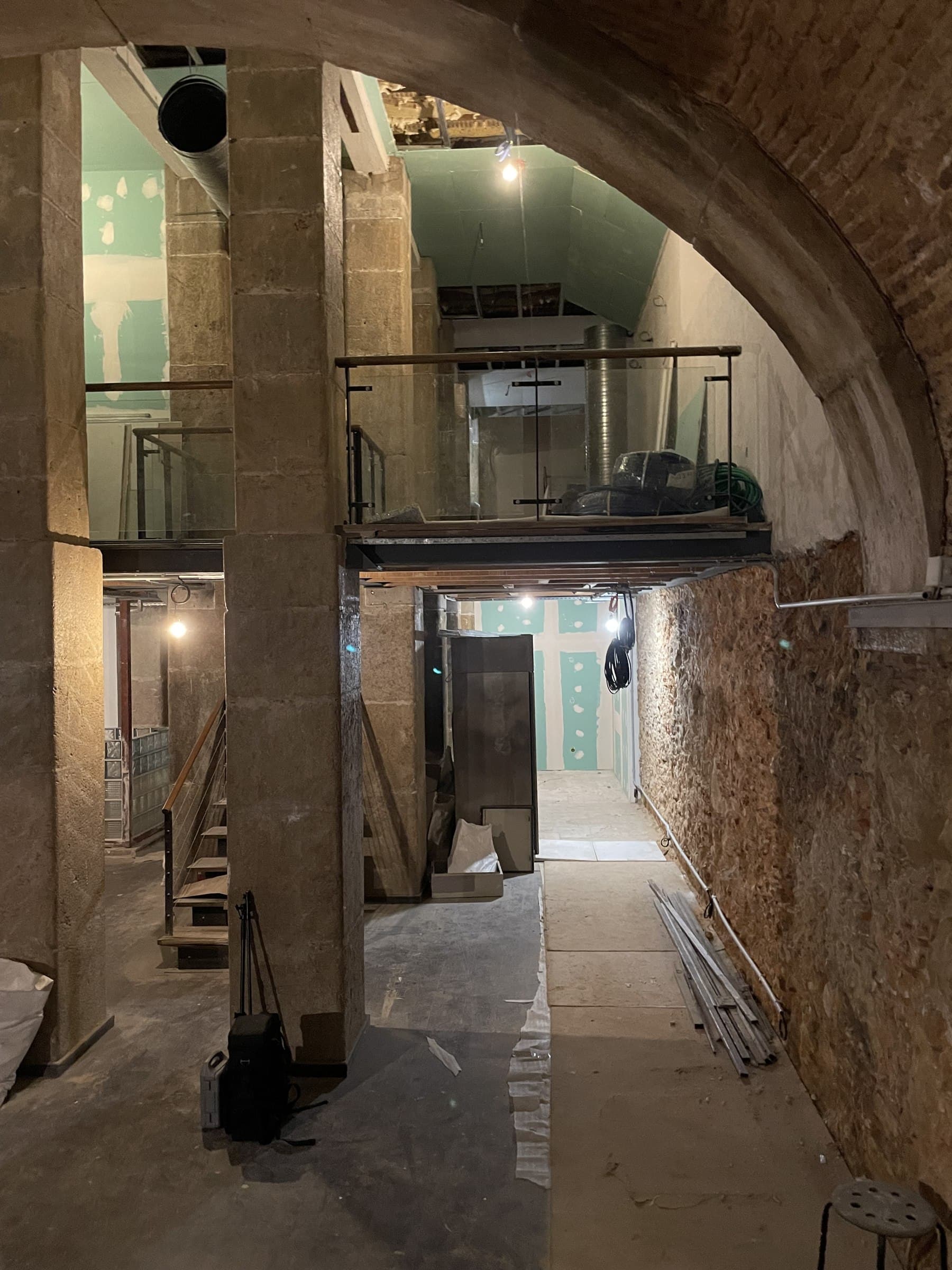 Stone archway and structural beam within the cellar during fit-out